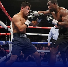 Two boxers trading punches in the ring